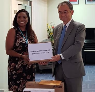 Mr. Doko presenting a donation to Ms. Leela Narayana, Assistant Director of Sunbeam Place